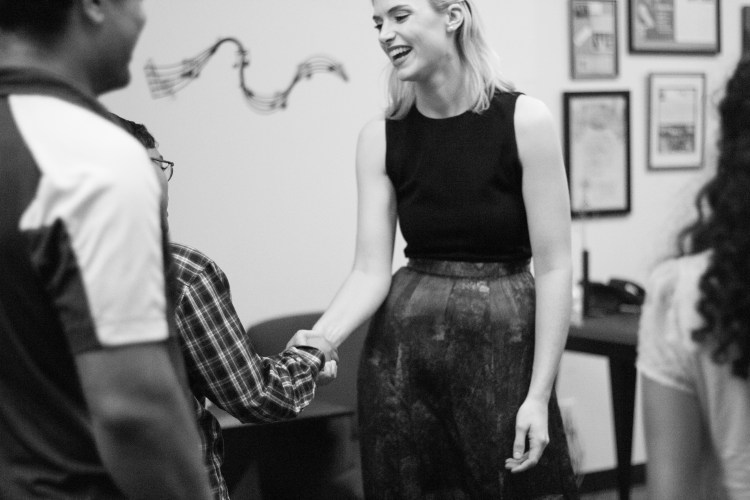 Asher, violin, congratulates Ms. Haley